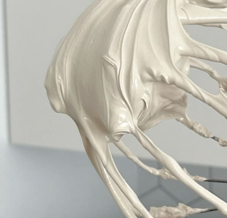 Black ice bucket with four wine bottles and a glass stopper on a wooden table, labeled 'CHAMP ACADEMY'.