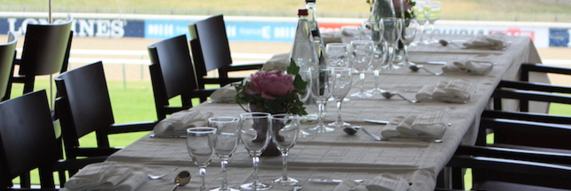 Ornate indoor balcony with intricate wrought-iron railing, white columns, and classical architectural details.