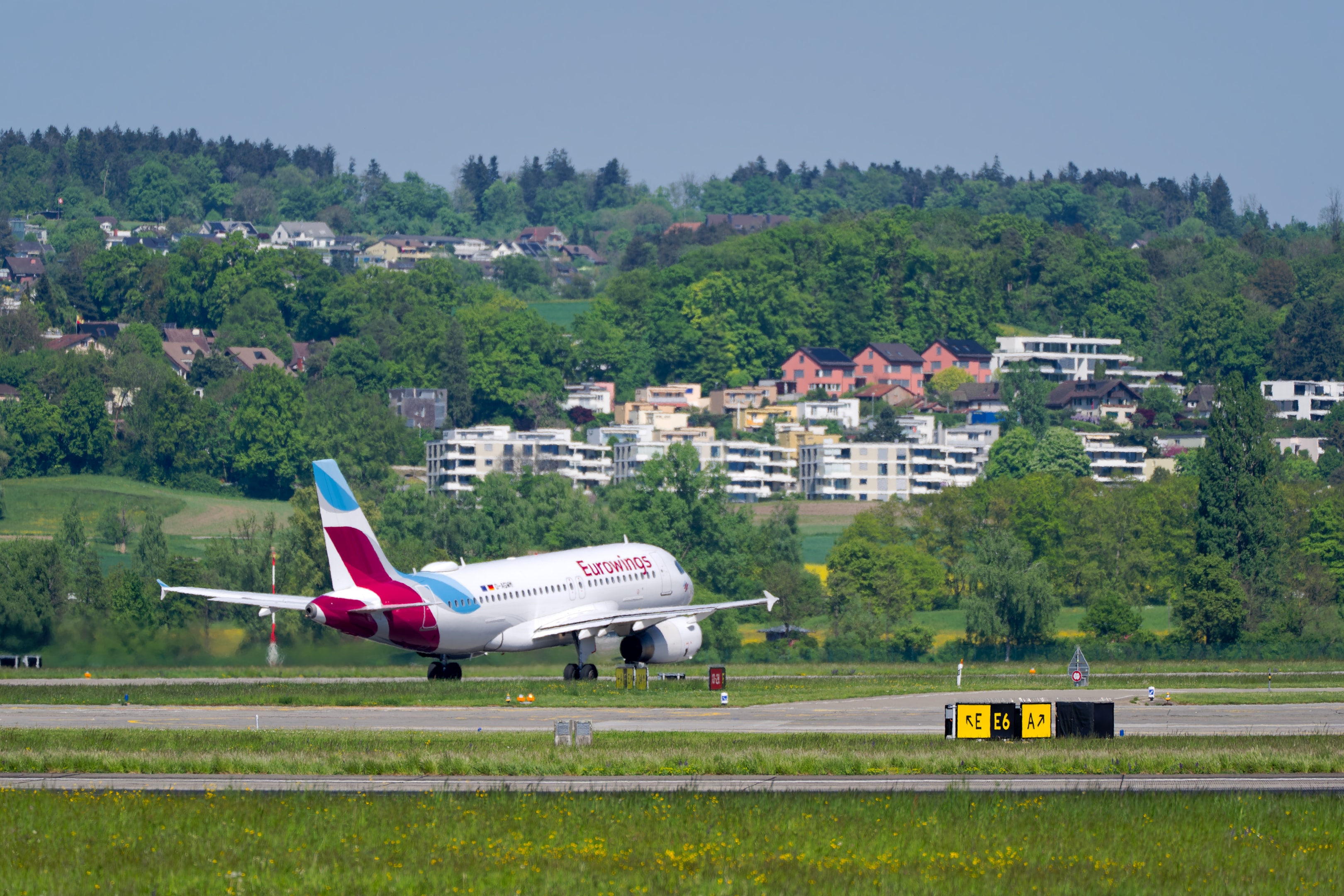 Passenger airplane Eurowings Airbus A319-132 registration D-AGWM taking off from Swiss Airport Zürich Kloten on a sunny spring day. 