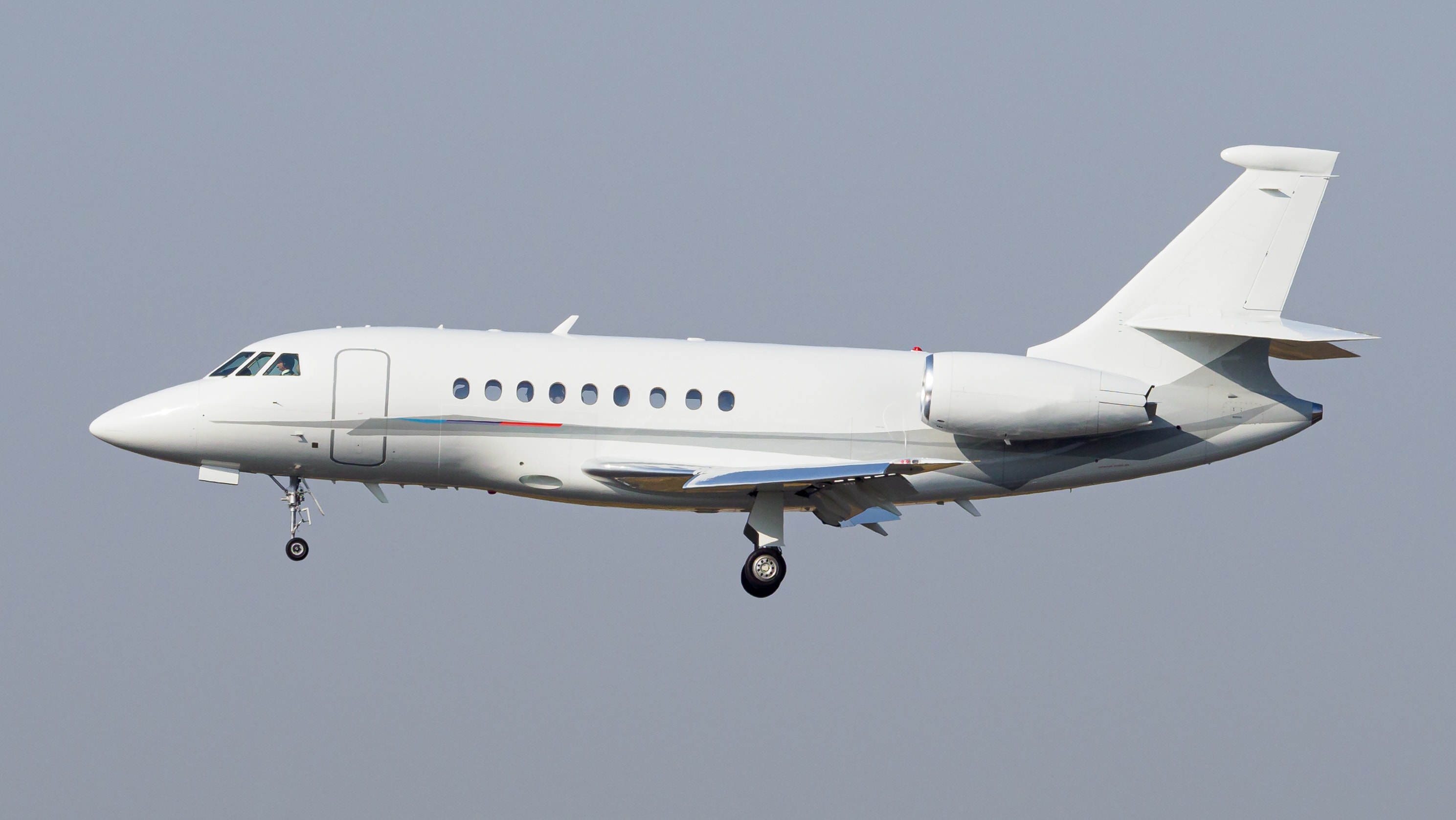 A business jet flying with gray background