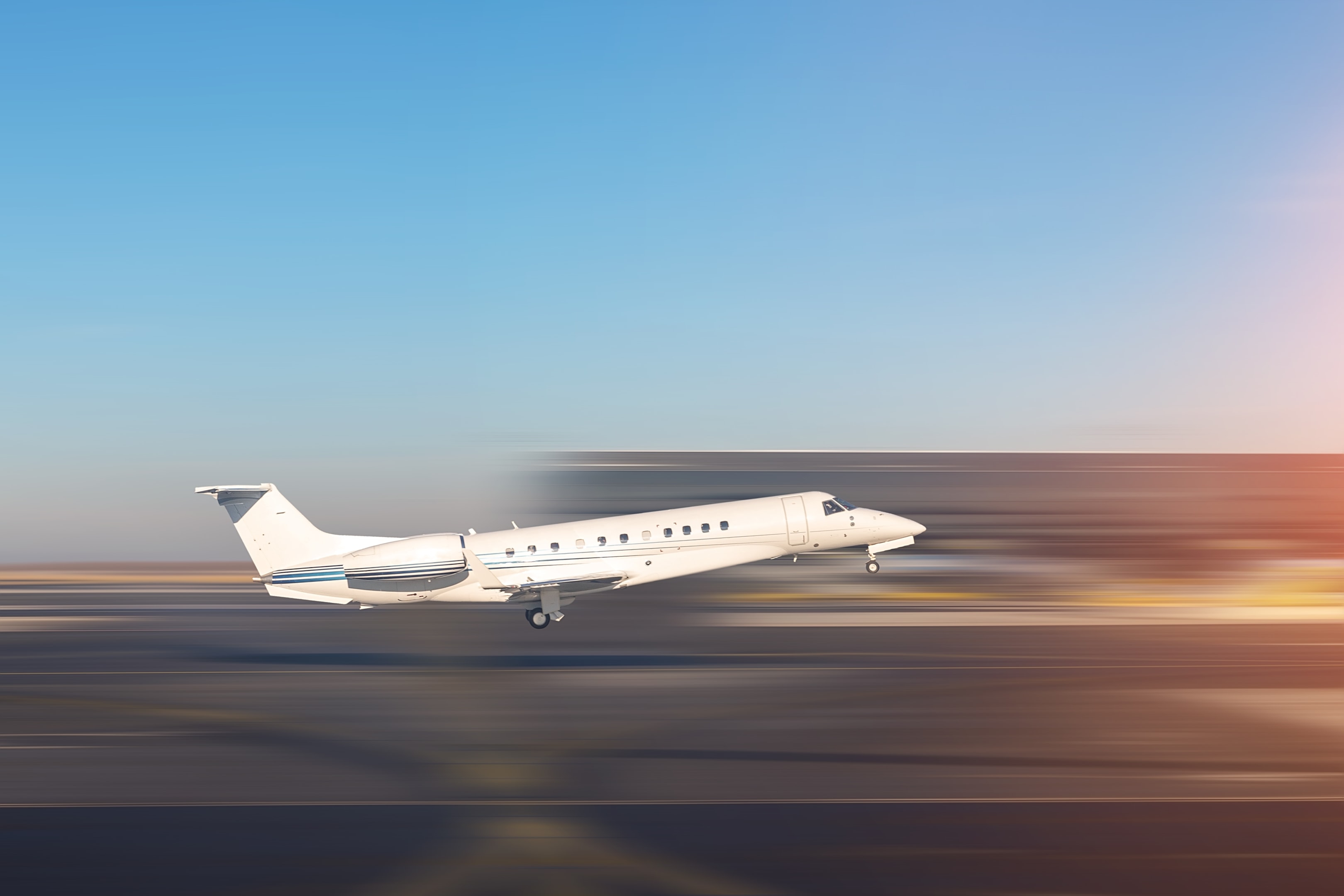Mid size modern vip private jet departure and take-off on airport runway.