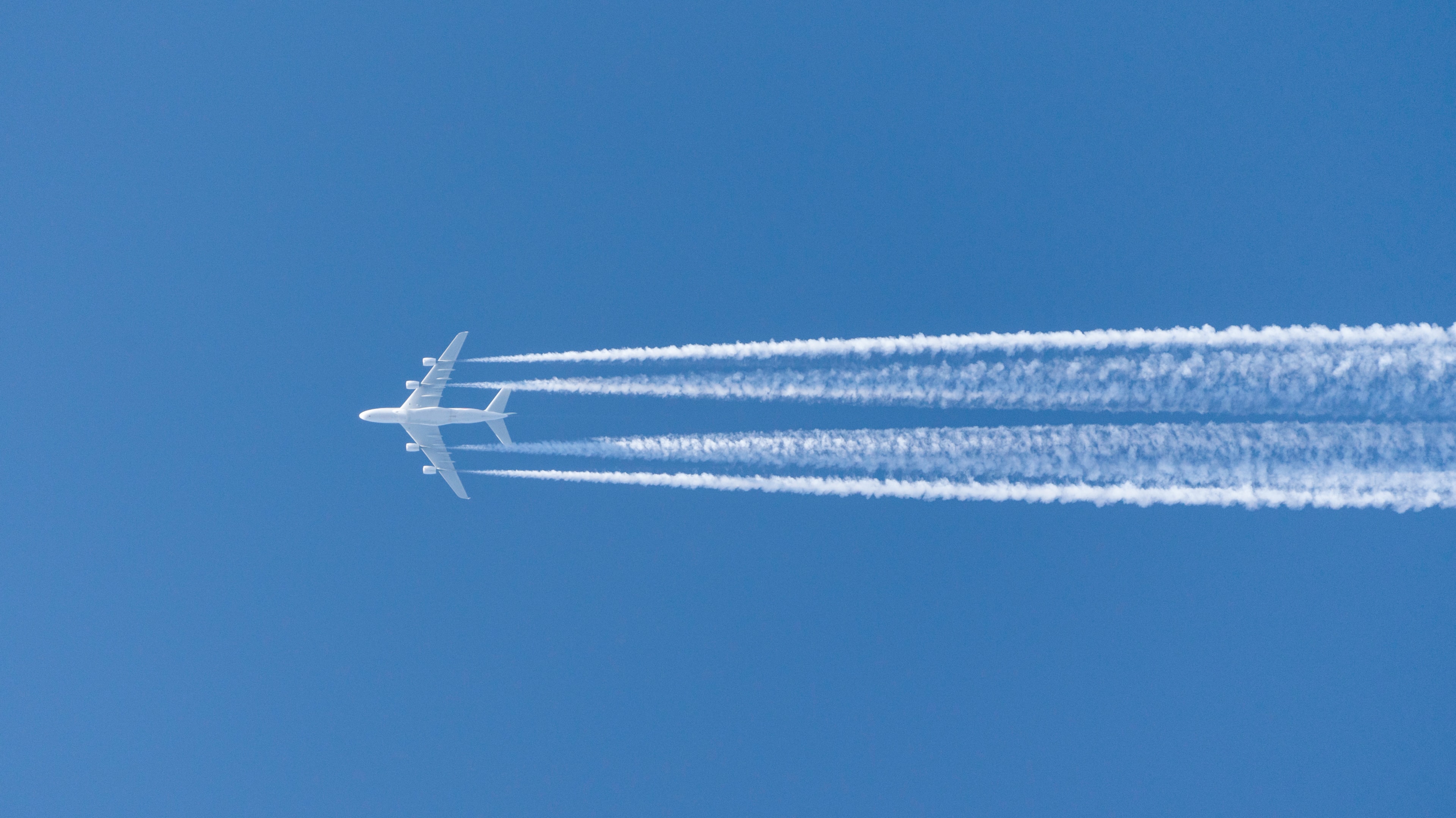  Jet airbus a380 airplane in the sky with condensation stripes