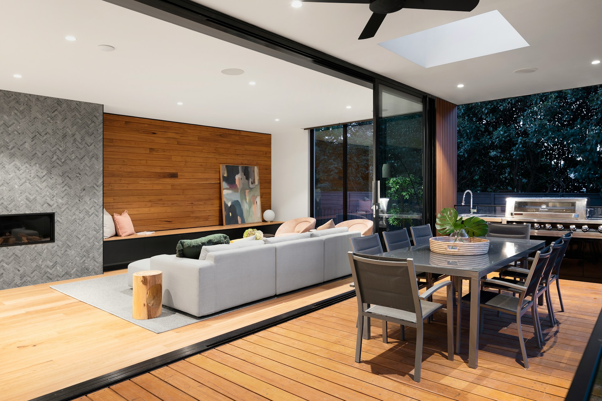 A living room with a couch a table and a fireplace.