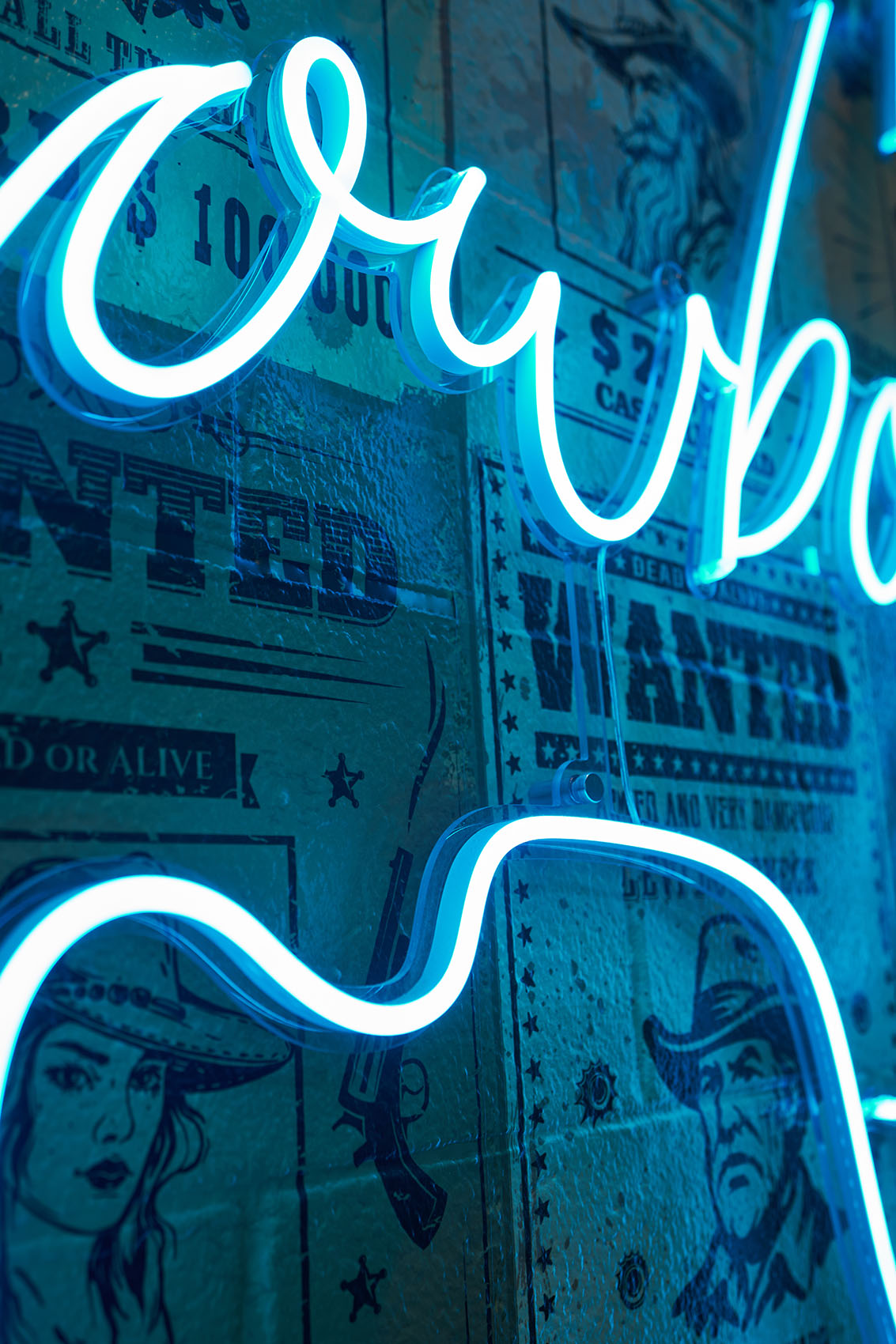 detail of neon sign with wanted poster wallpaper