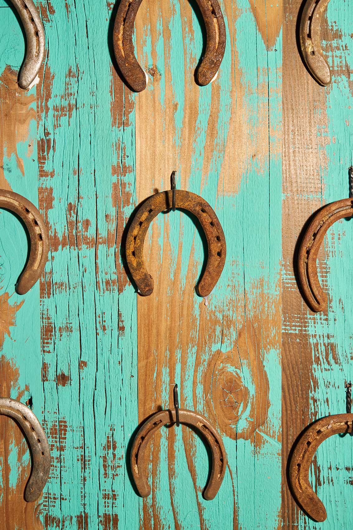 light paint wash on wood detail with horseshoe decorations