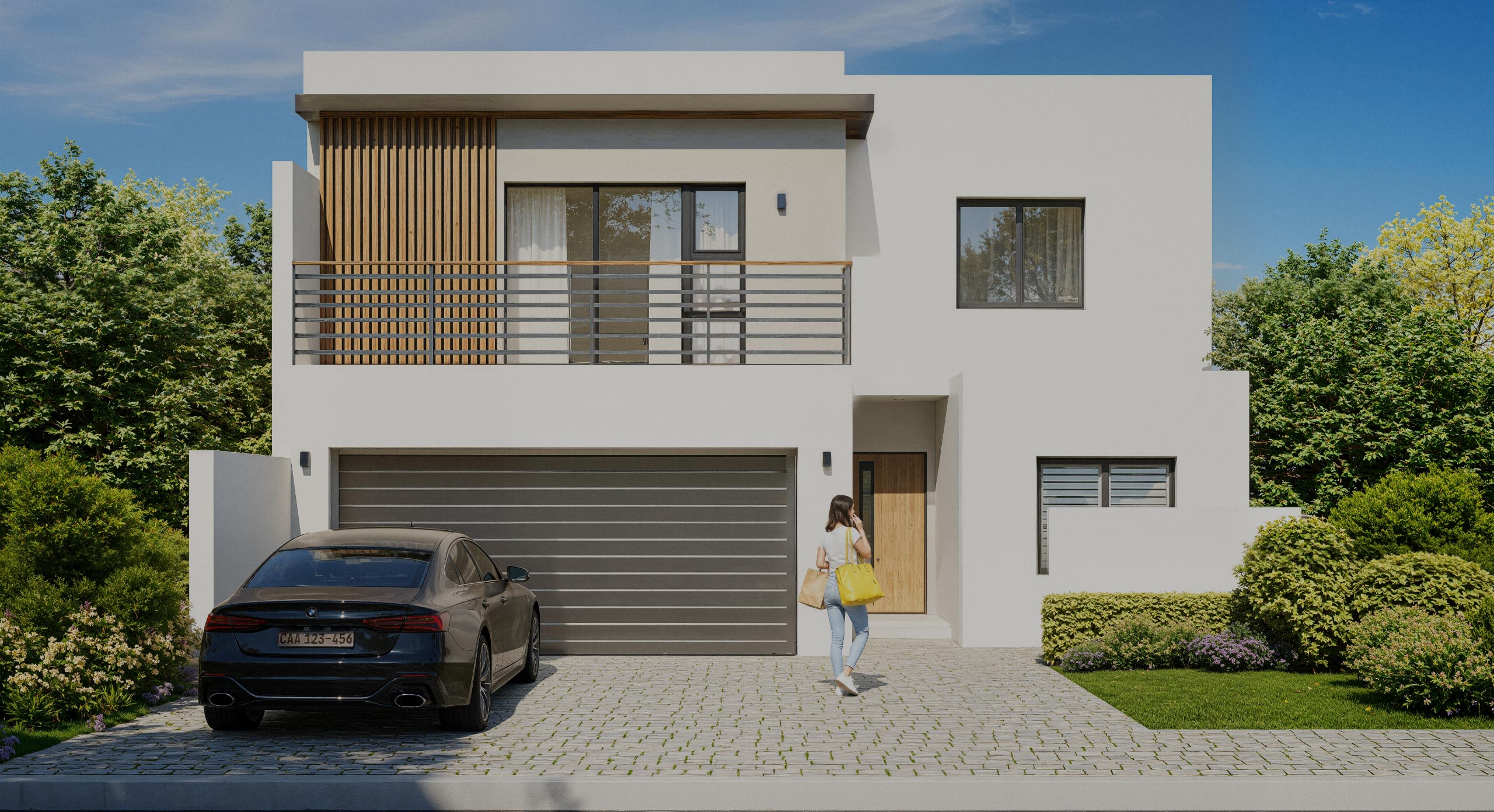 Modern two-story white house with a large garage, wooden door, balcony, and a woman walking towards the entrance carrying bags.