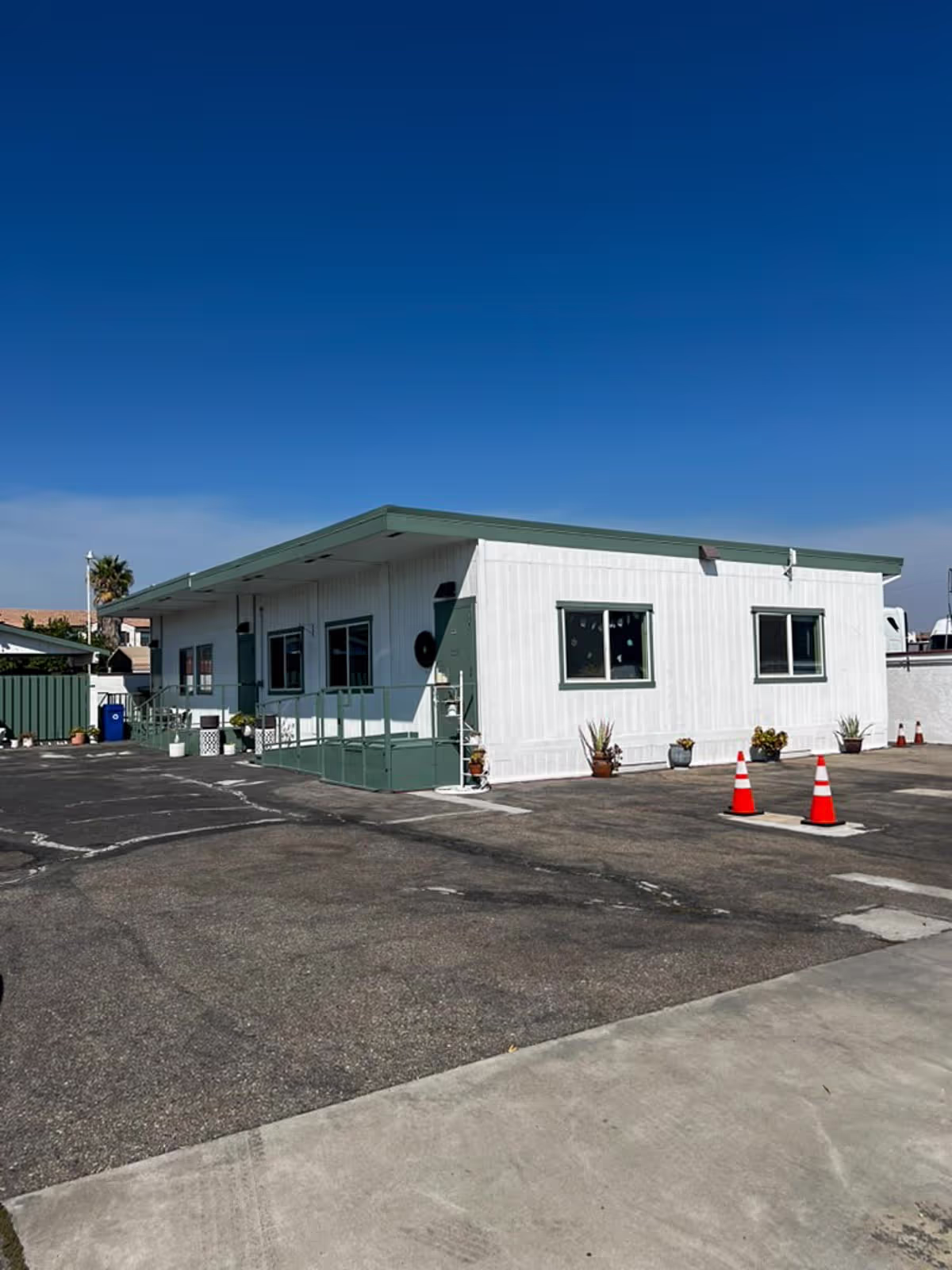 Refurbished modular building with fresh white siding and trim