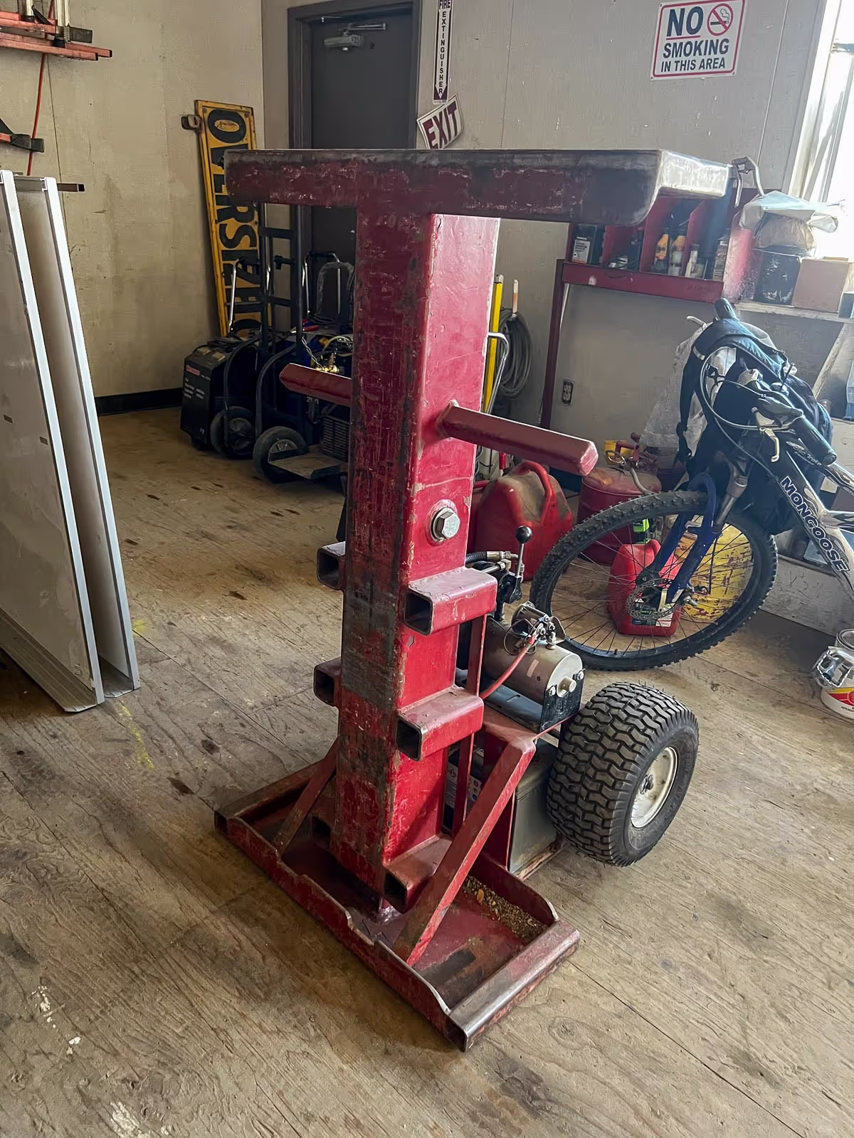 Red hydraulic lifting jack used for releveling modular buildings