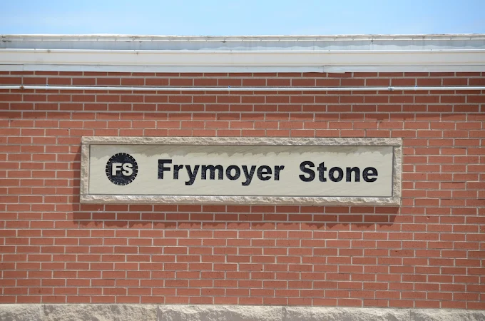 Brick Wall with Sign that reads Frymoyer Stone
