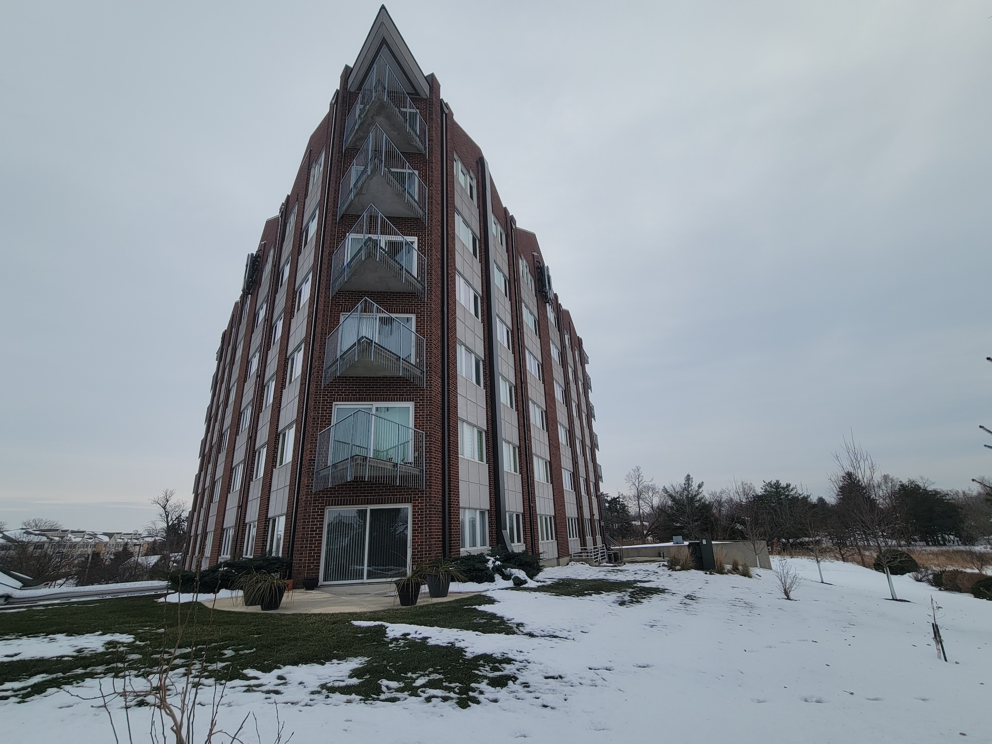 Mast climbing platforms staged on restricted site for cell tower masonry retrofit, Cedar Rapids, Iowa