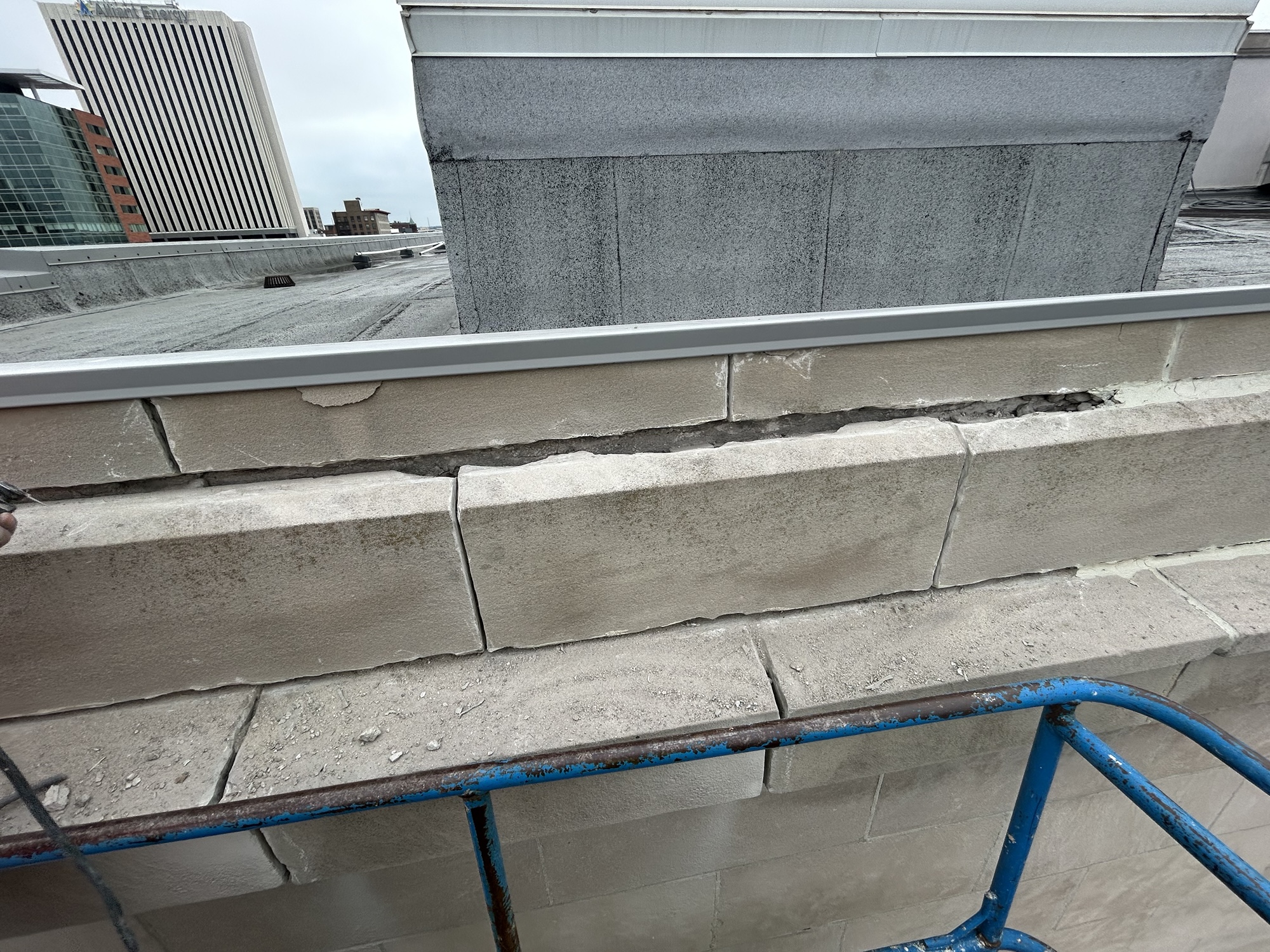 Open mortar joints on historic masonry facade at Linn County Courthouse before tuckpointing