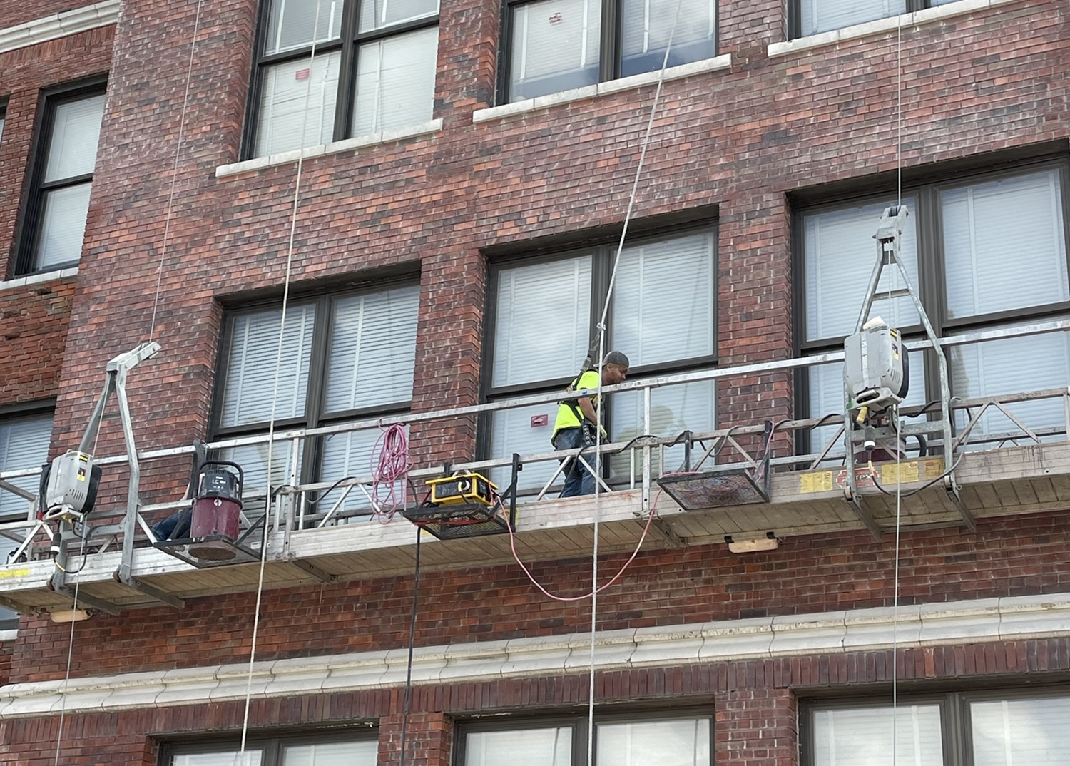 TNT Tuckpointing crew performing building maintenance on a commercial masonry facade — September 2025 Brick and Banter