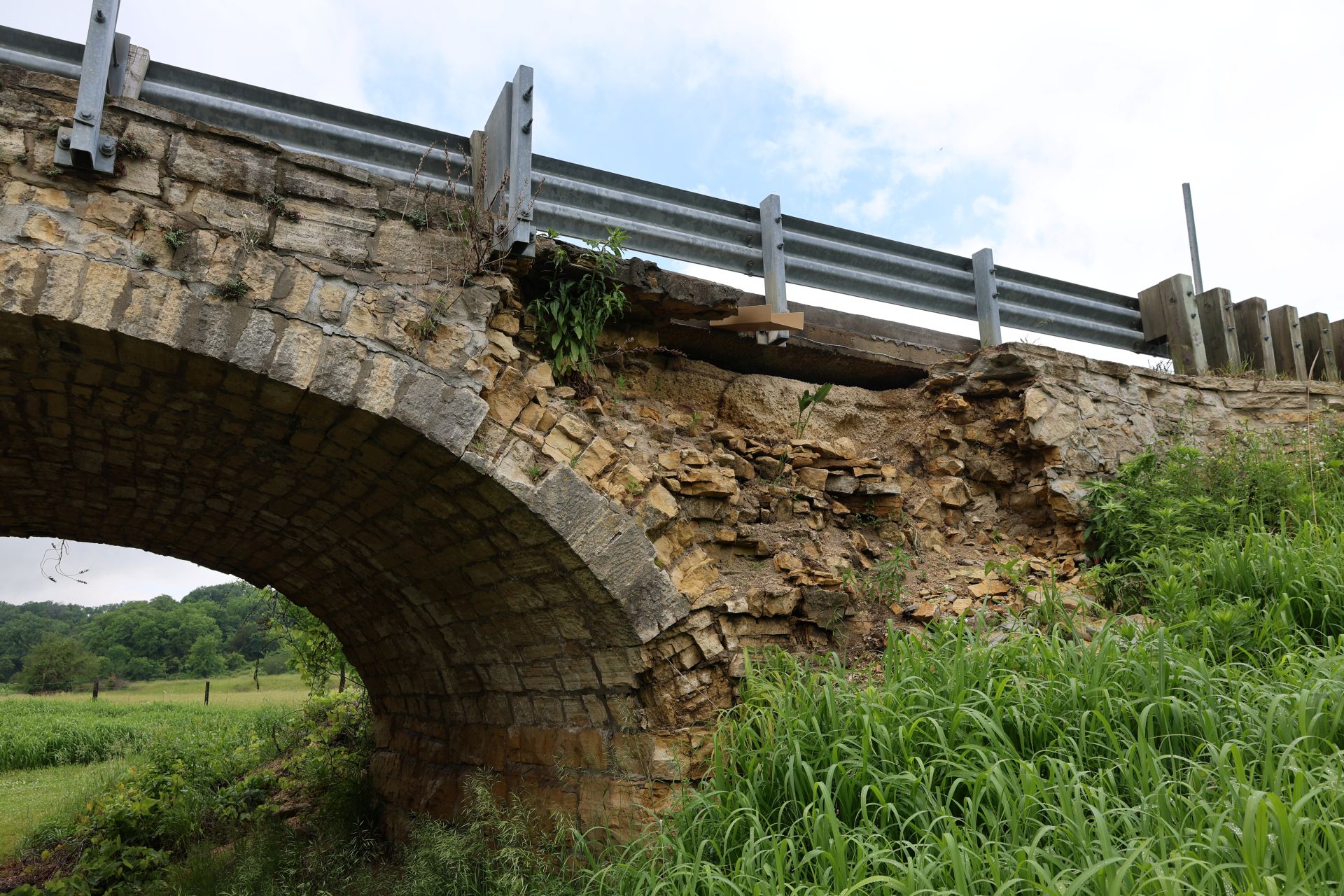 Failing spandrel wall above a sound elliptical arch ring at Ely's Stone Bridge.