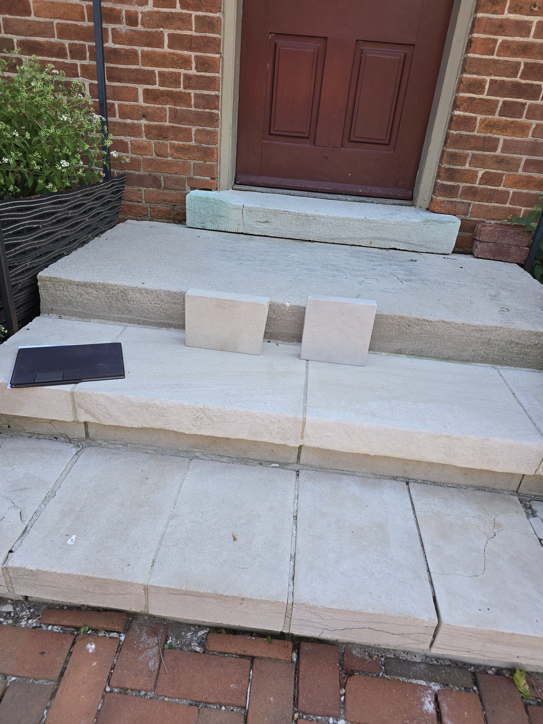 Color-match samples set on the historic limestone entry steps for review