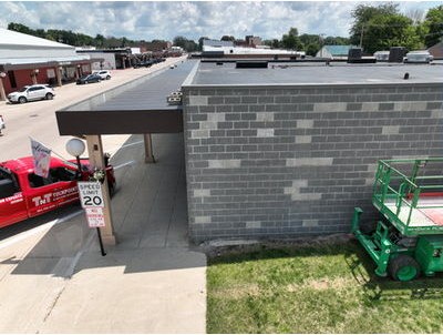 Aerial view of Green Belt Bank & Trust in downtown Belmond, Iowa, with a TNT truck and lift