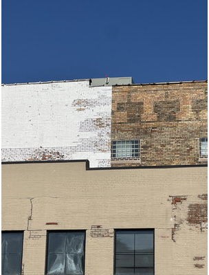 TNT mason tuckpointing the west facade of Orchestra Iowa's building in Cedar Rapids, Iowa