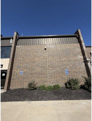 Masonry gymnasium wall at Lisbon High School in Lisbon, Iowa, after tuckpointing and brick repair by TNT Tuckpointing & Building Restoration