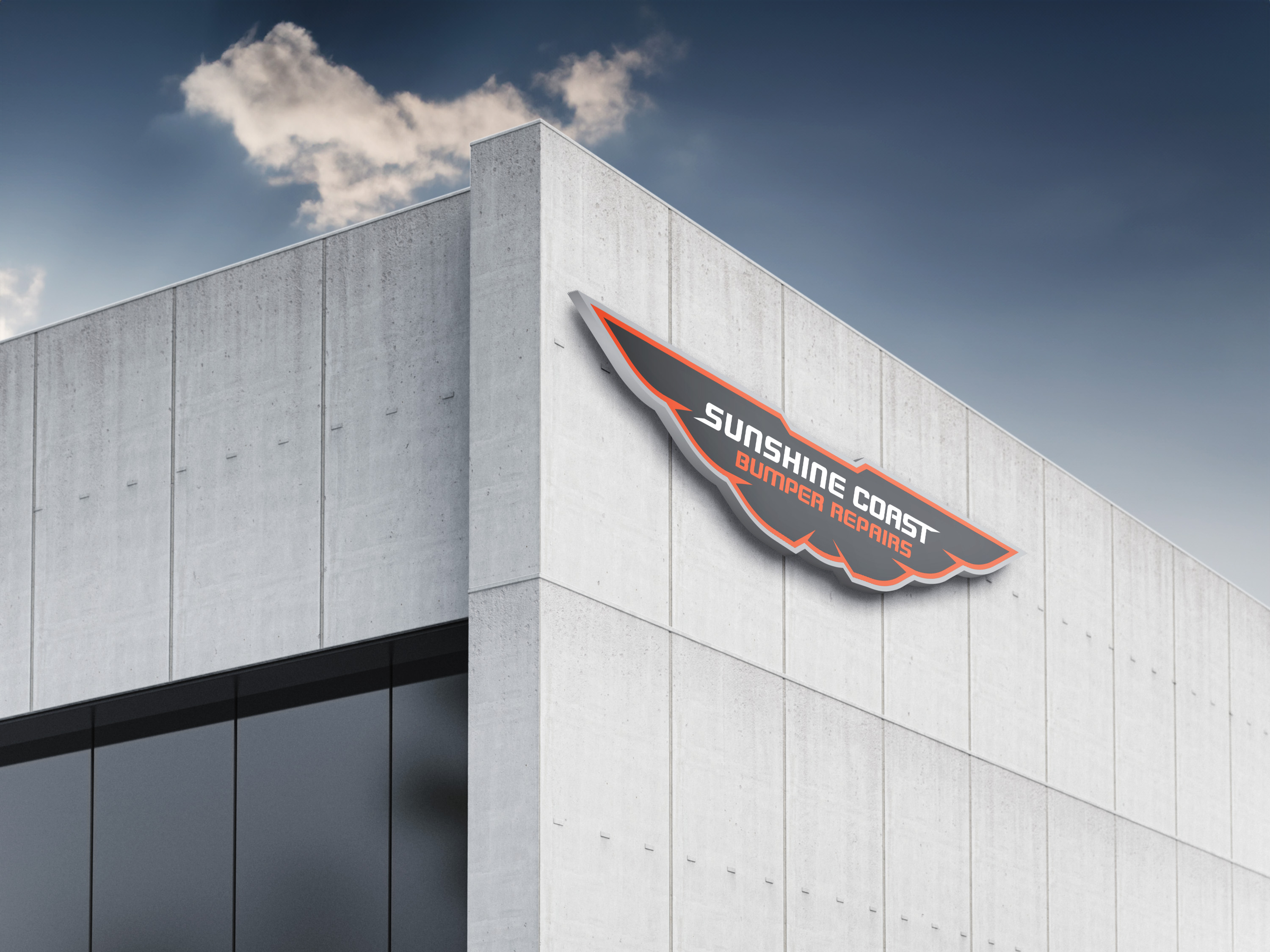 The Sunshine Coast Bumper Repairs logo on the side of a building.