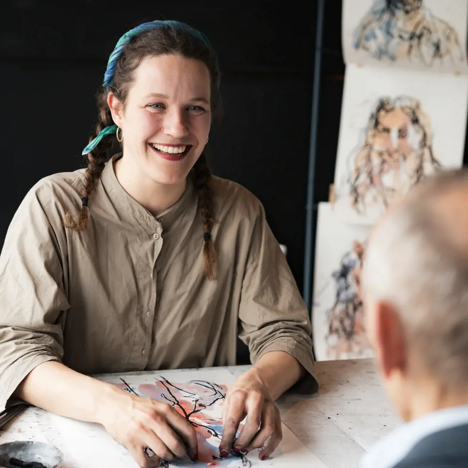 Iris drawing a guests at an event