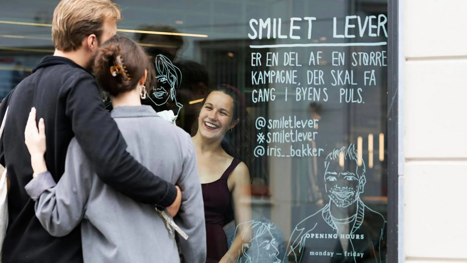 Iris draws portraits on window