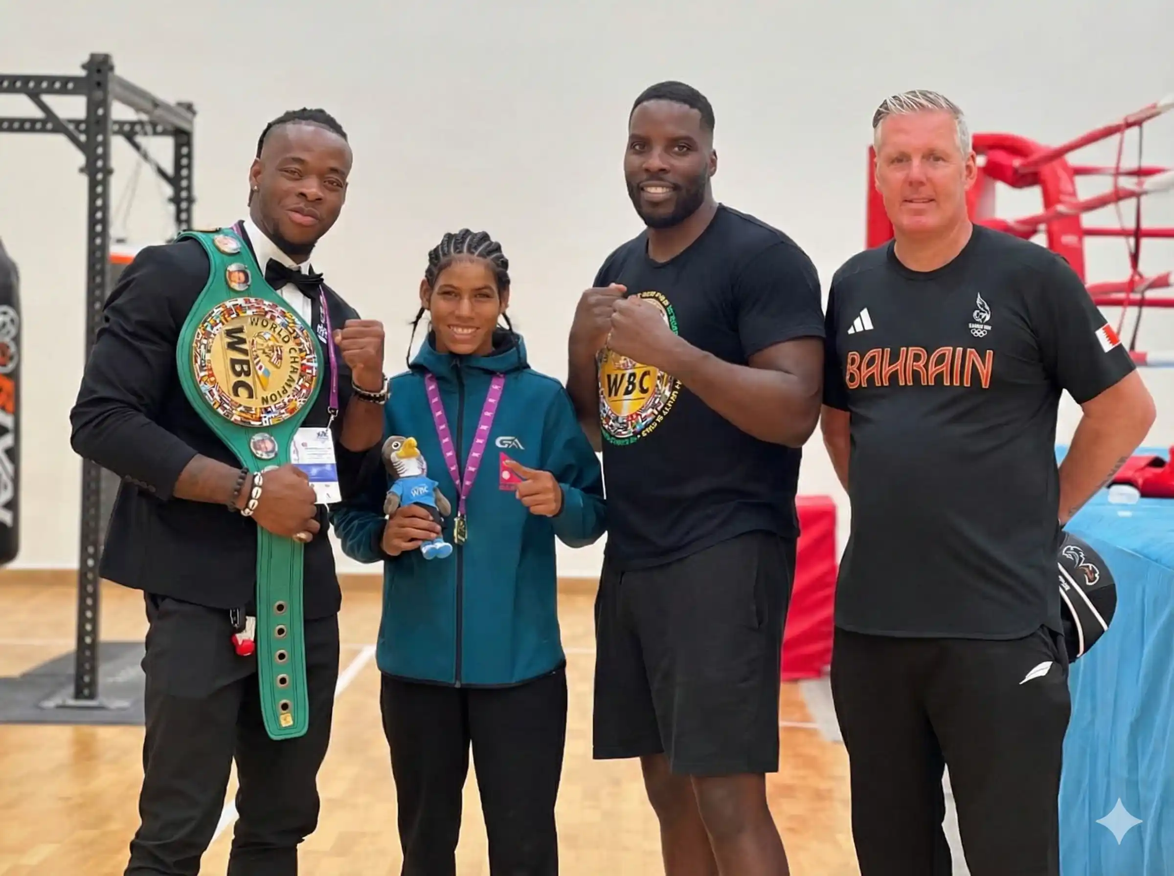 Fighter and coach holding bahrain boxing championship title
