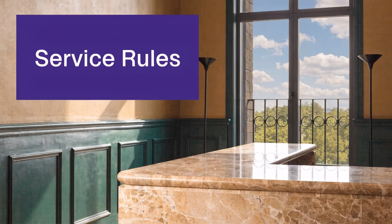 A luxurious marble front desk in an elegant office interior with a large window and green paneling.