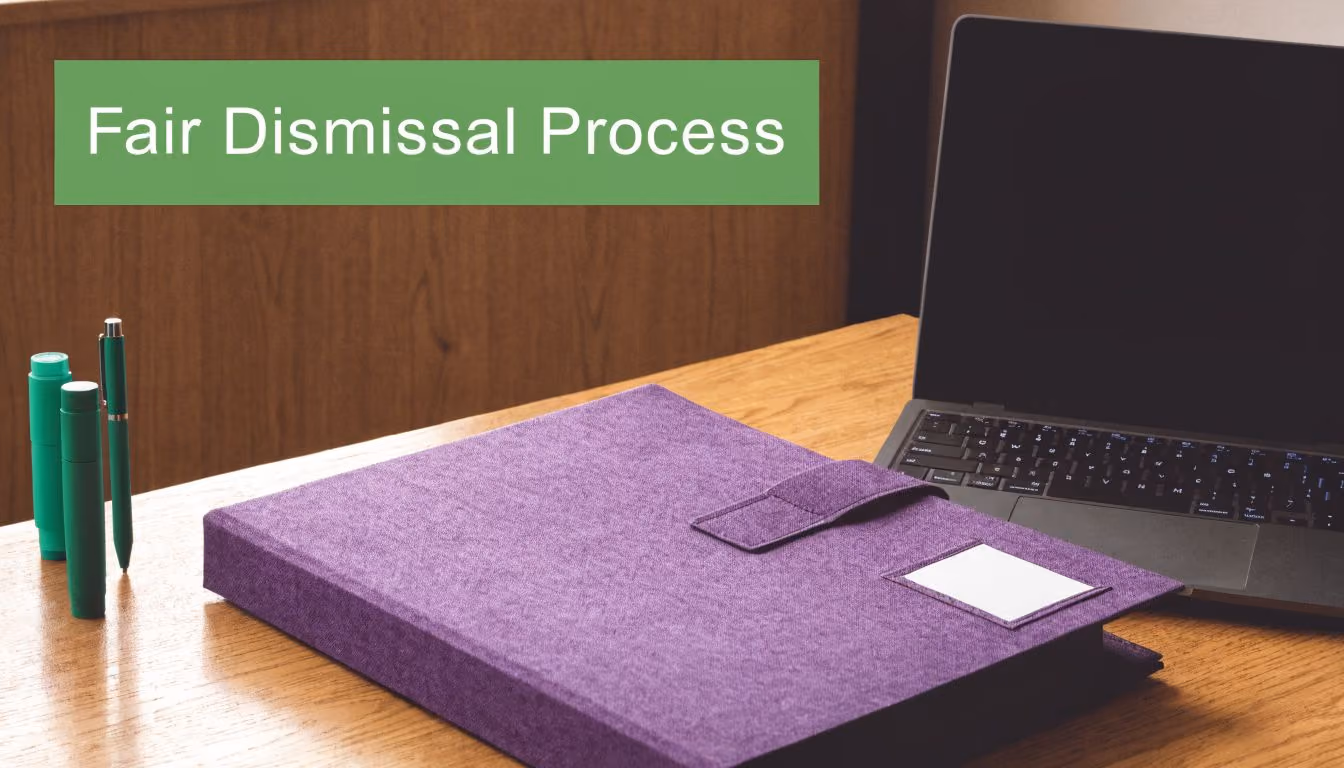 A purple binder and laptop on a wooden desk, symbolizing professional human resources document preparation.