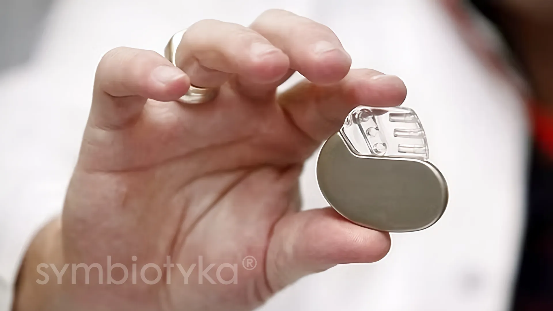 A person holding a small metal object in their hand.
