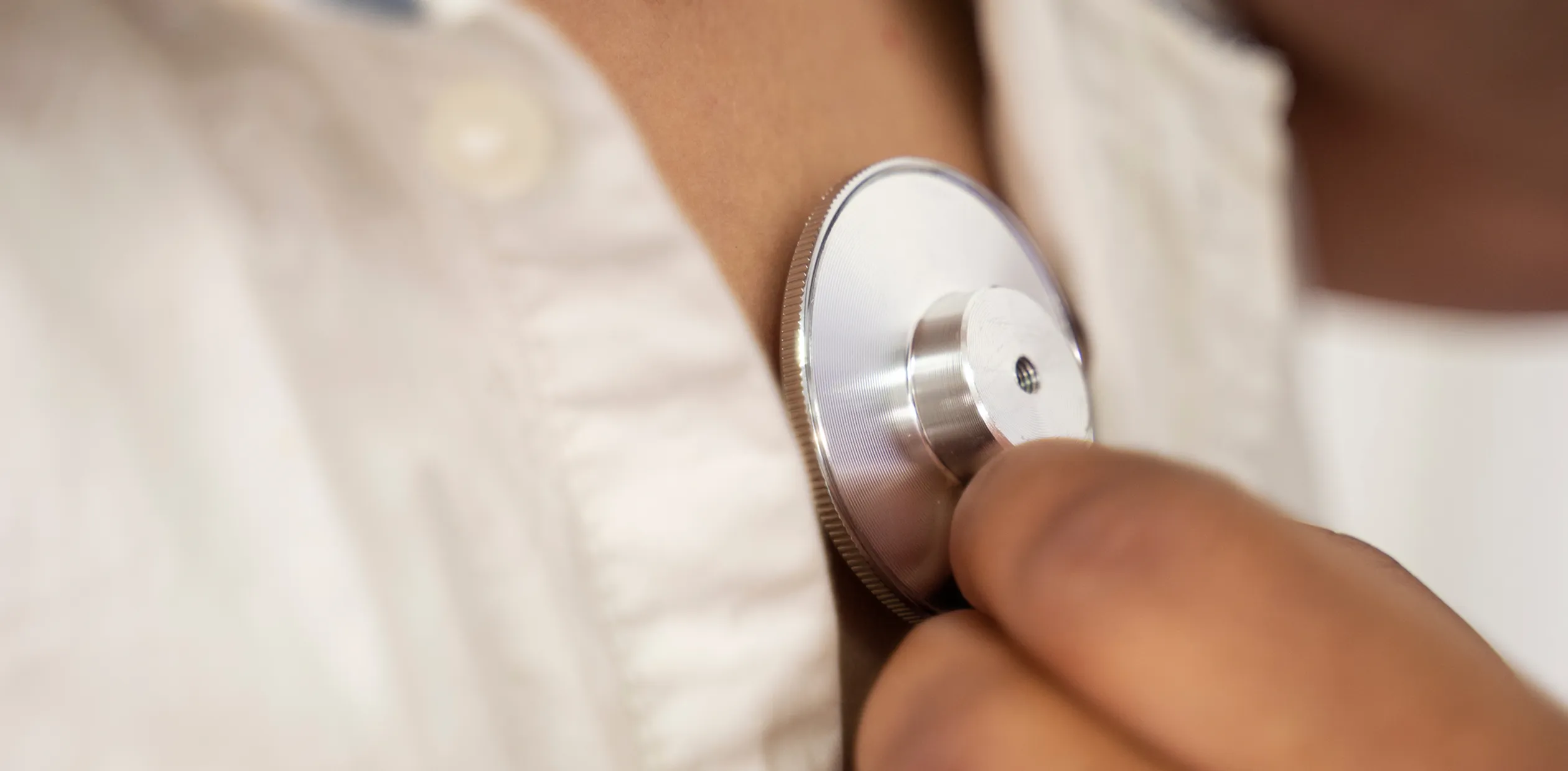 A close up of a person holding a small device.