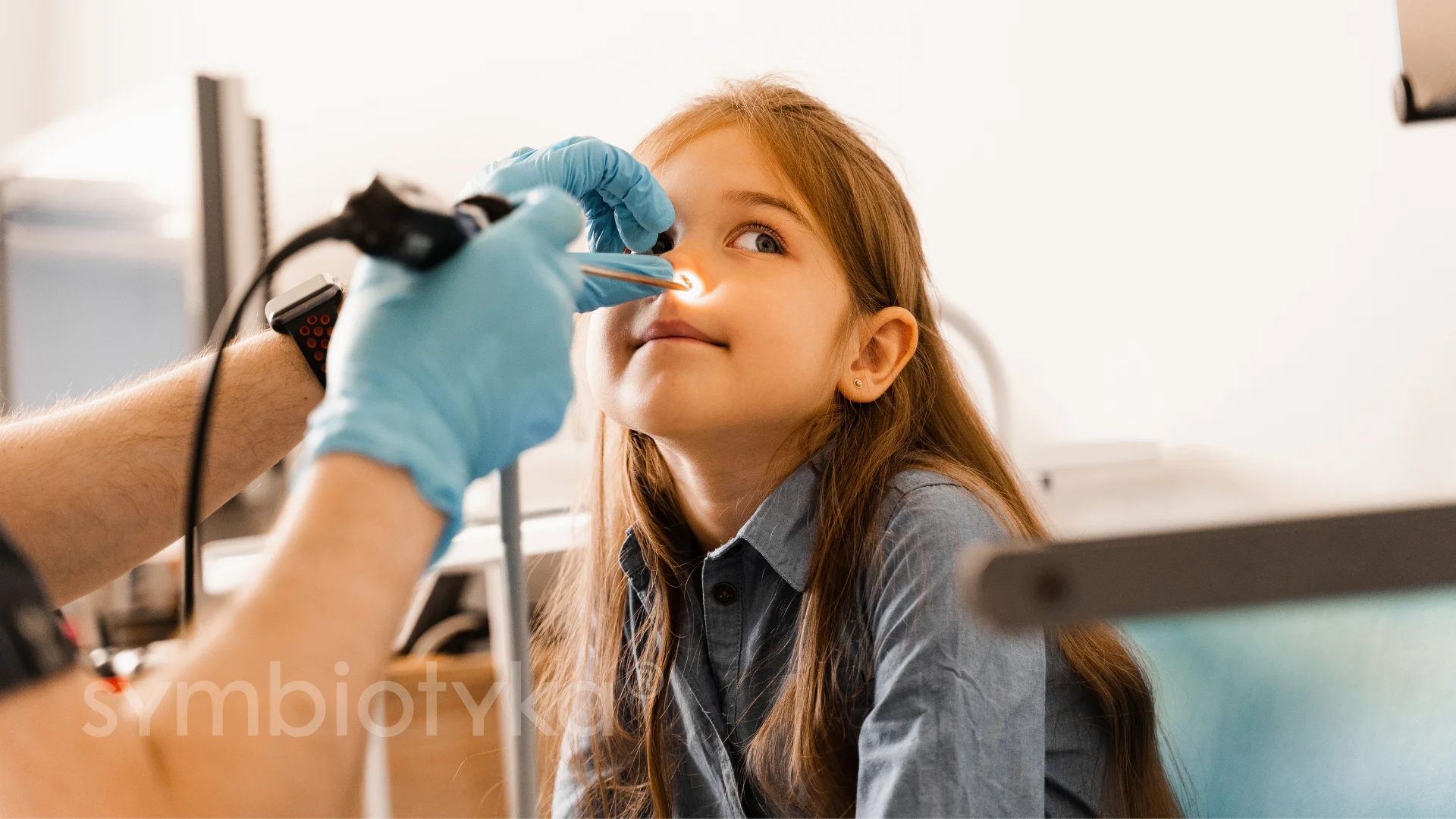 A young girl getting her teeth checked by a dentist.