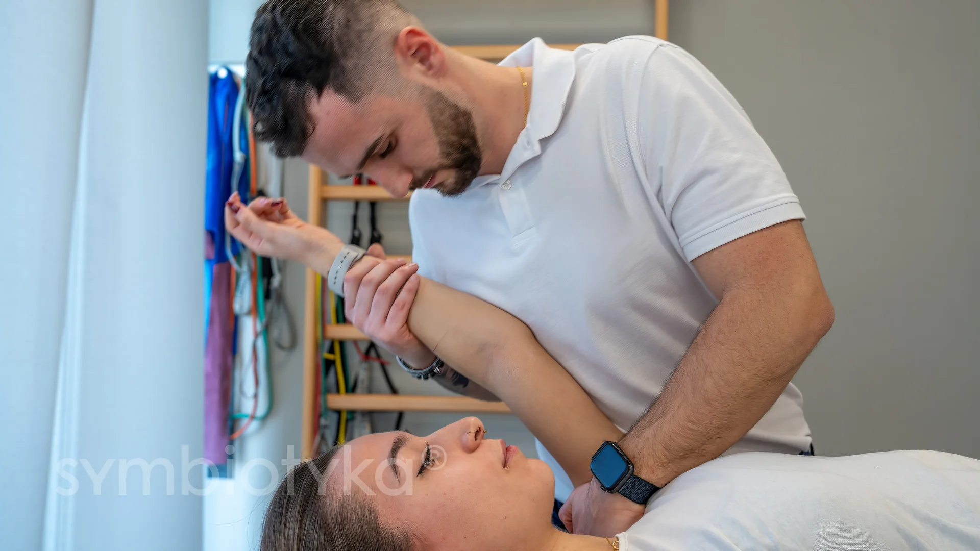 A man helping a woman put on her watch.