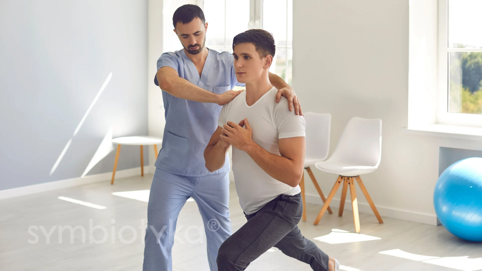 A couple of men standing next to each other in a room.
