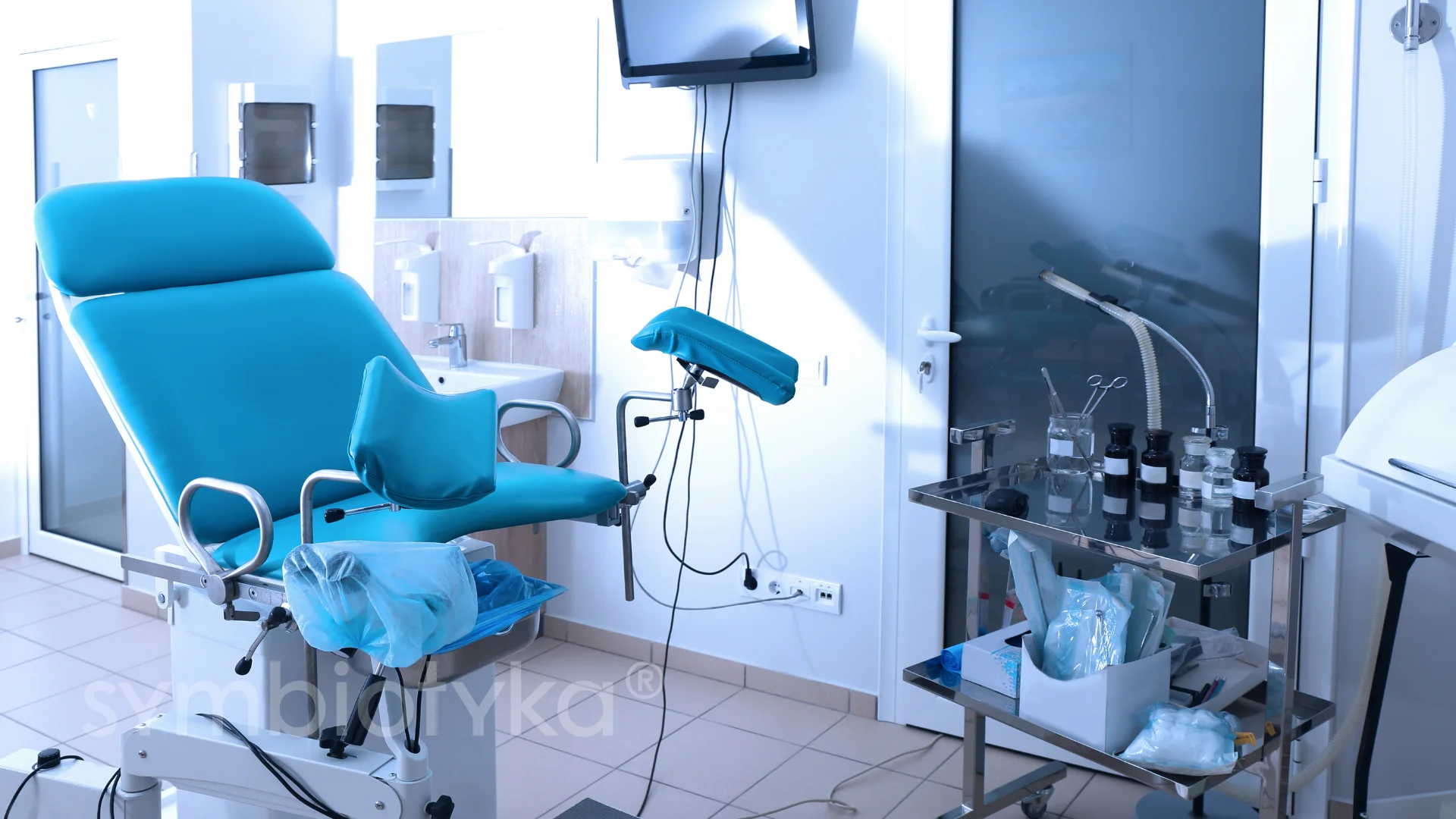 A blue chair in a room with a tv.