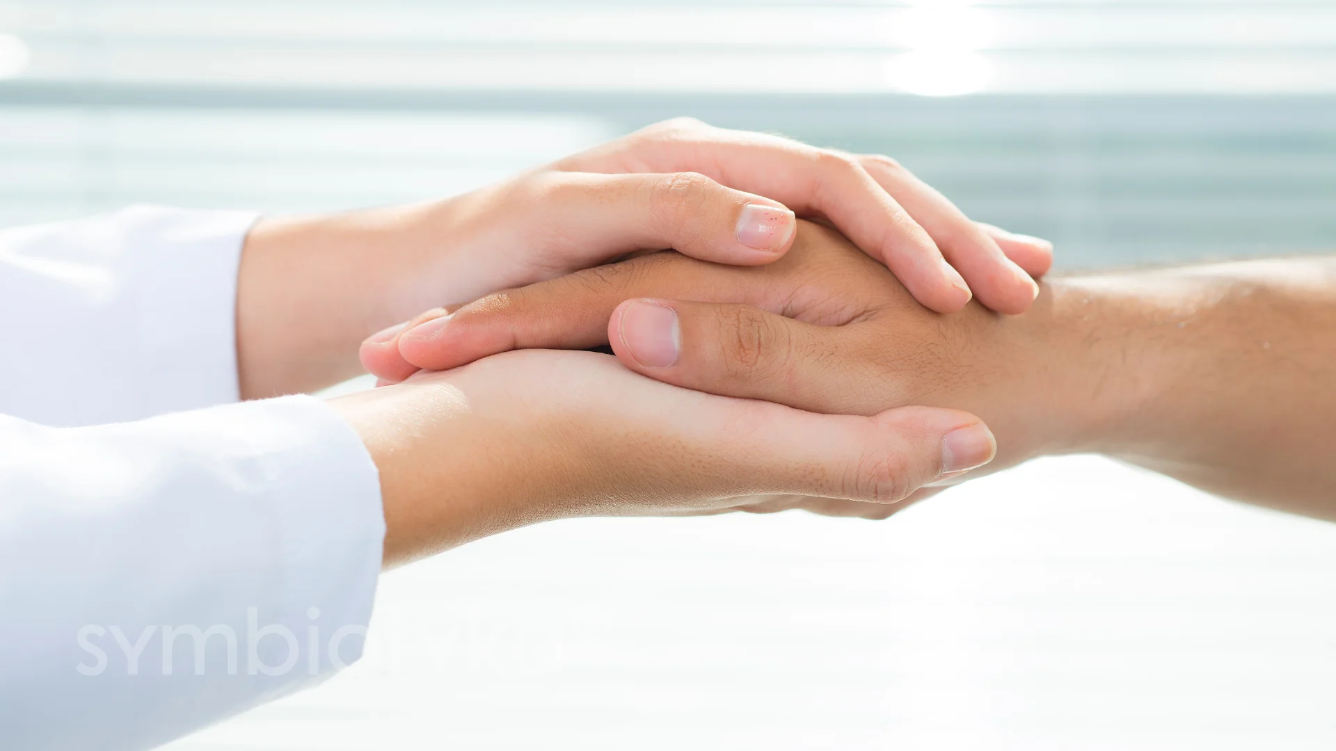 A close up of two people holding hands.