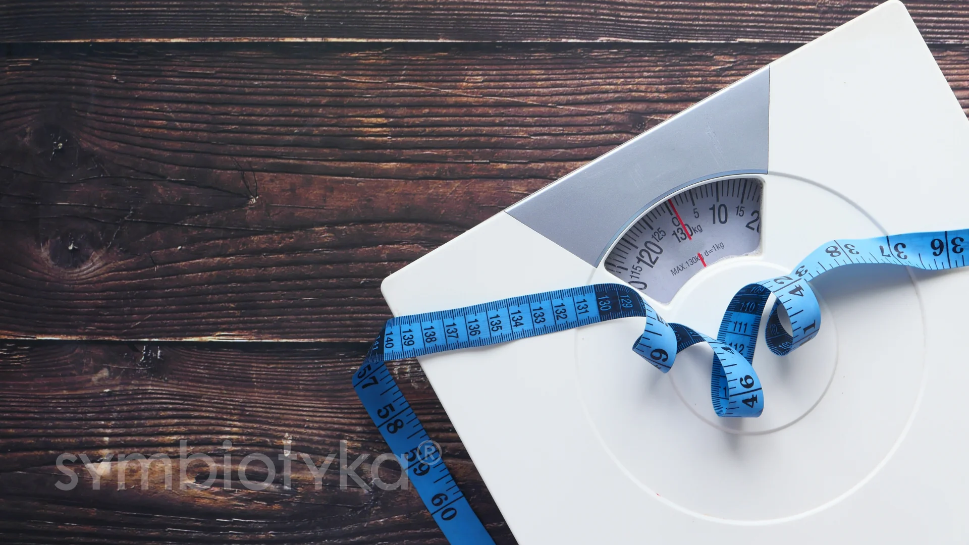 A weight scale with a measuring tape around it.