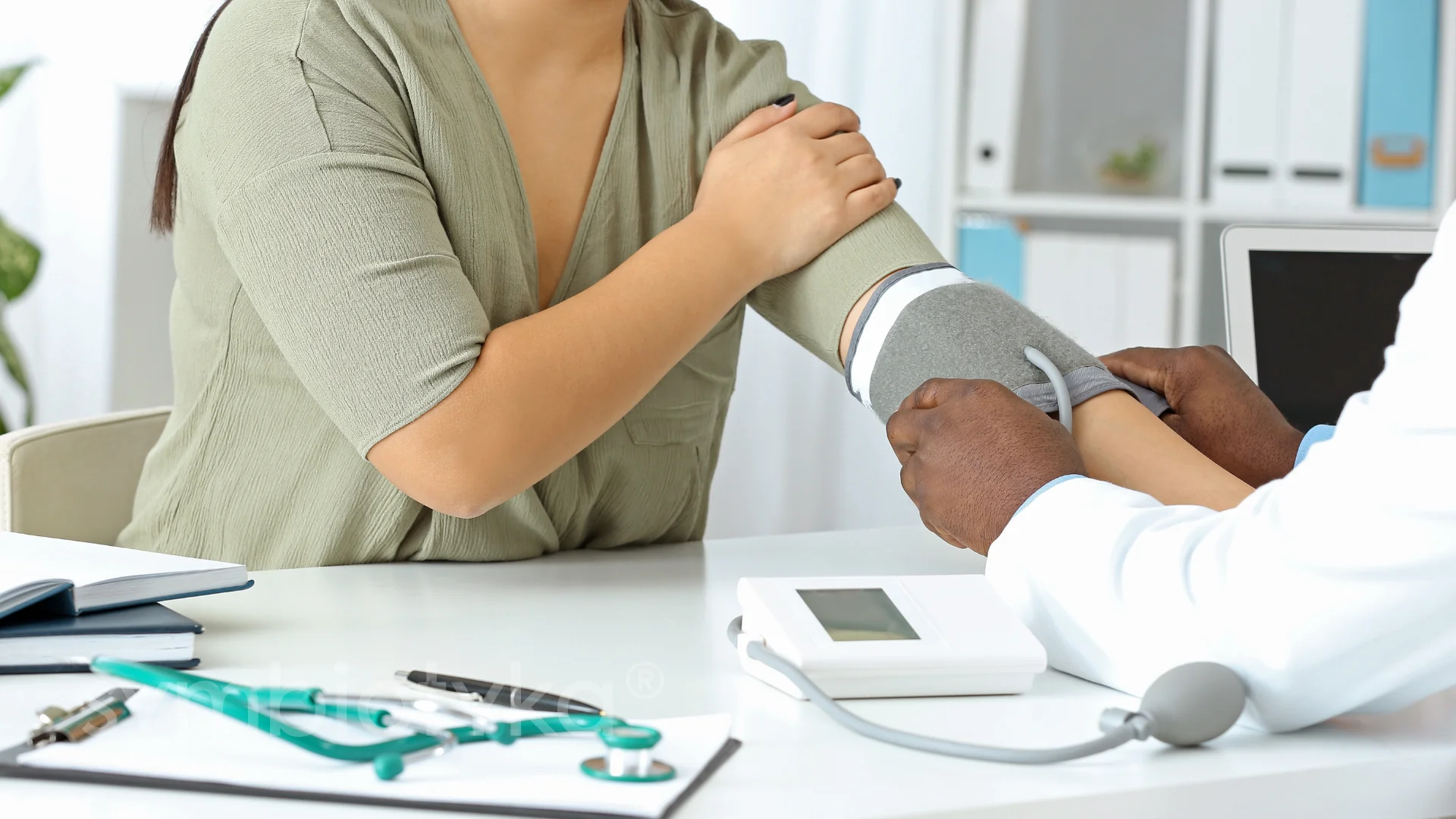 A doctor is holding the arm of a patient.