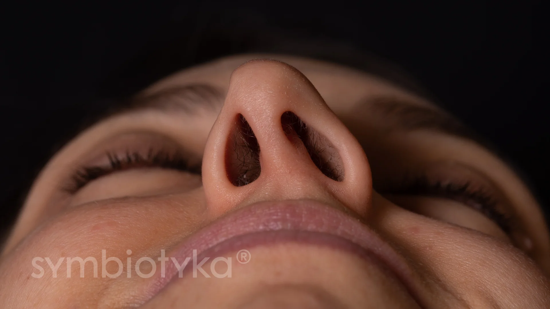A close up of a person with a nose ring.