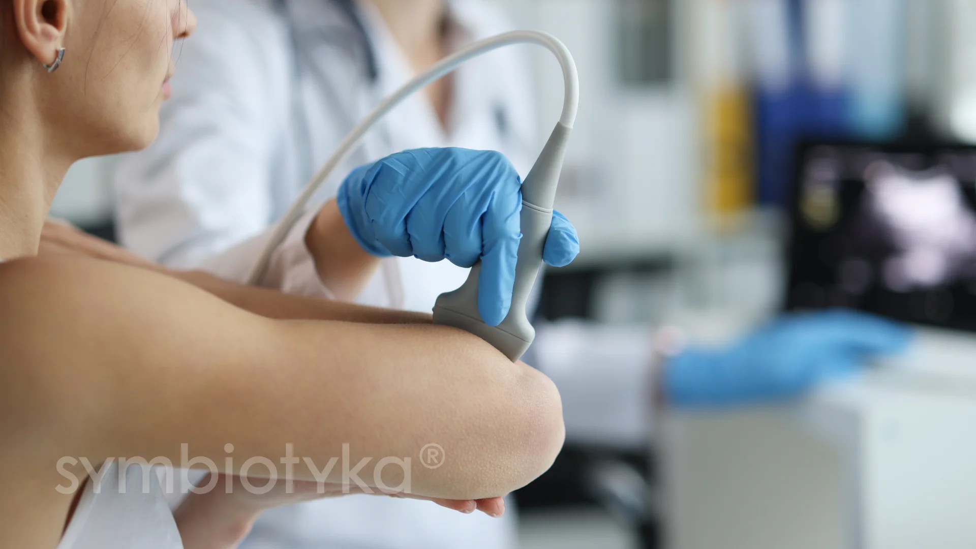 A woman with a blue glove and a stethoscope.