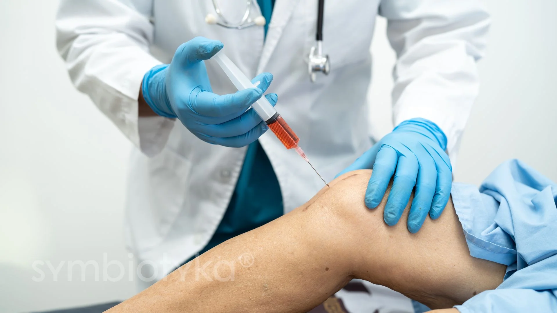 A doctor performing a procedure on a patient's leg.