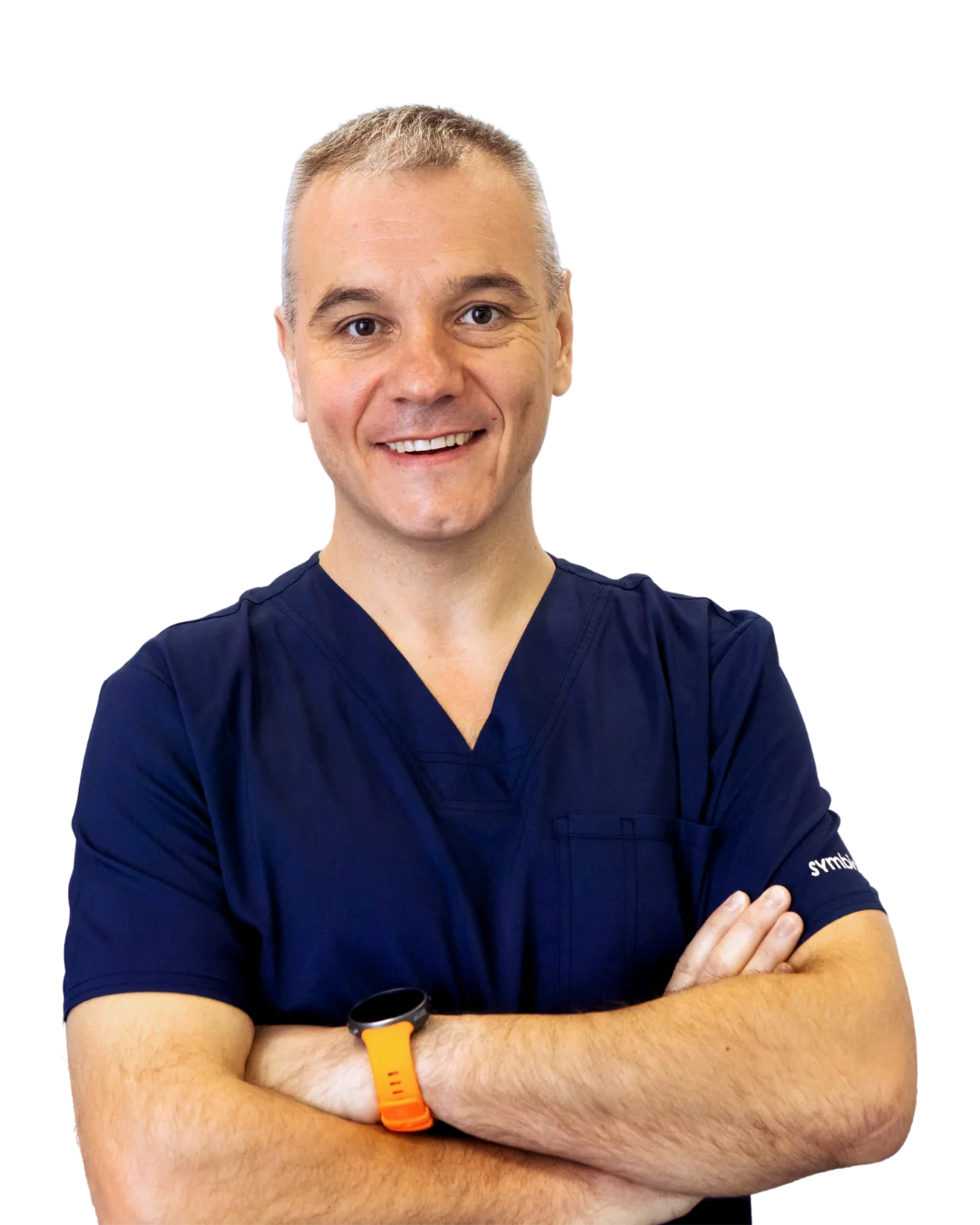 A man in scrubs with his arms crossed.