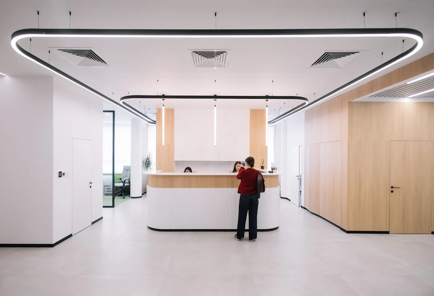 A person standing at a counter in a large room.