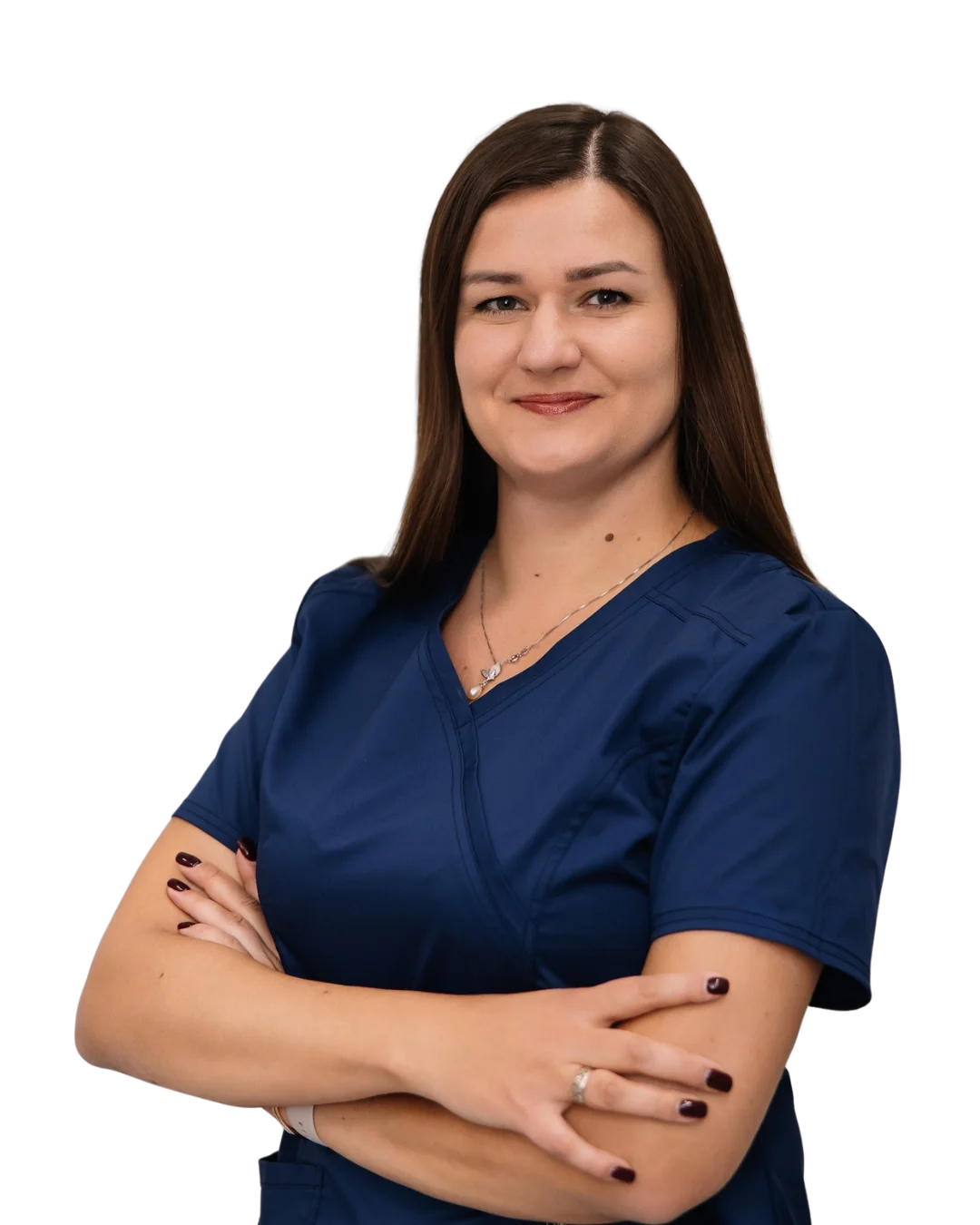 A woman in scrubs with her arms crossed.