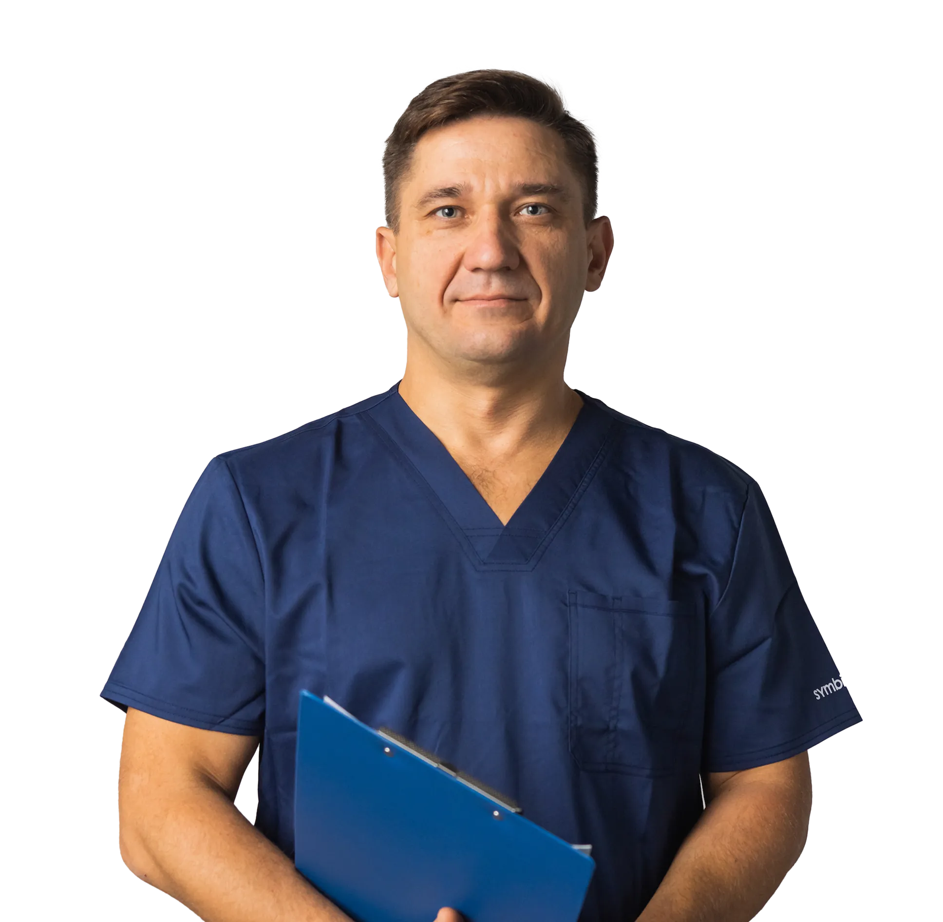 Middle-aged male healthcare professional in navy scrubs holding a blue clipboard.