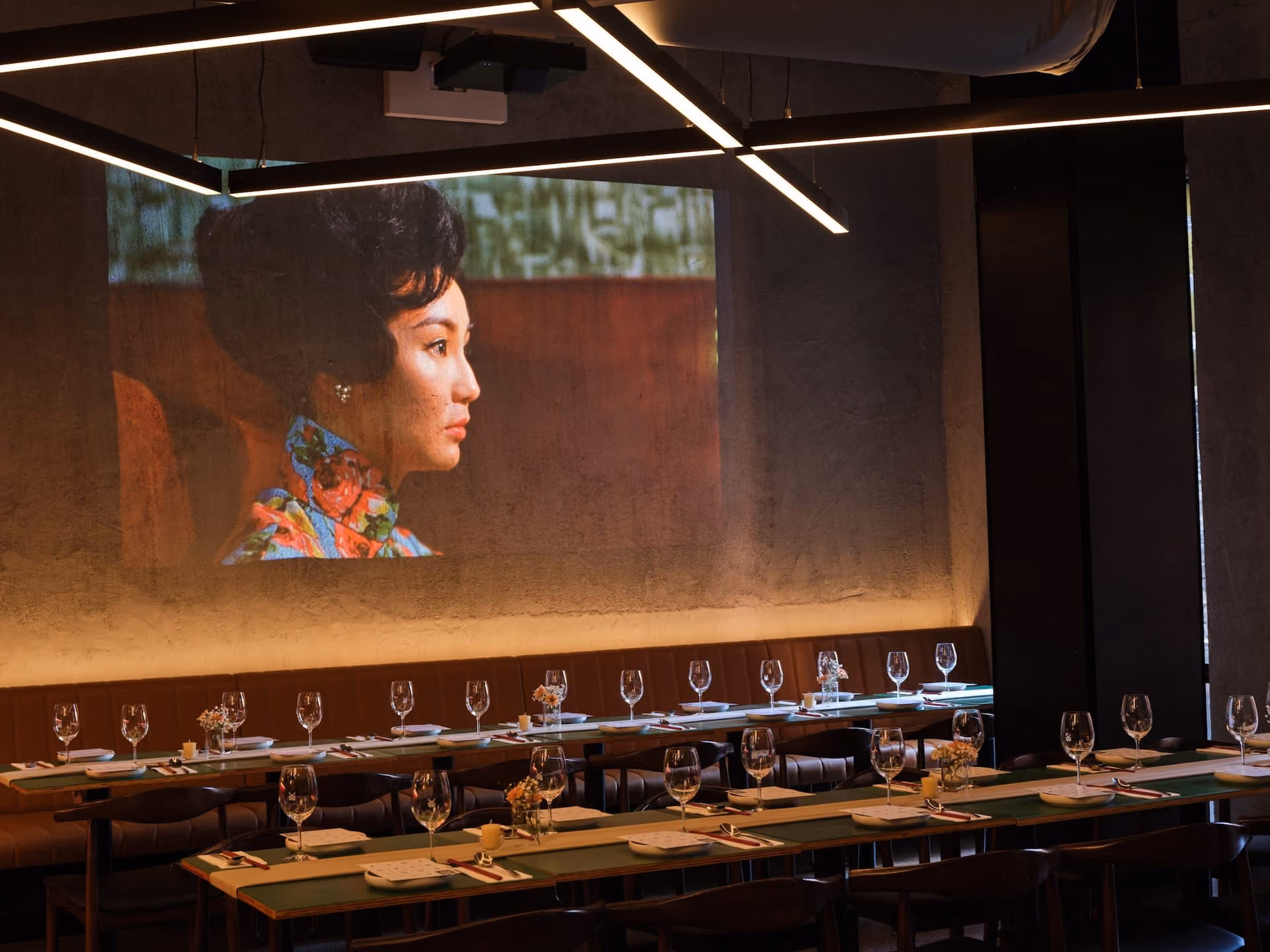 Yum Sing House dining room with wall projector