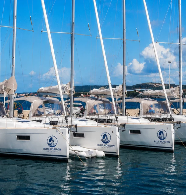 Row of charter sailing yachts moored at a marina