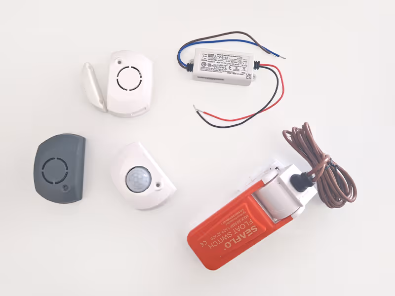 Collection of Sentinel marine sensors including a bilge float switch and wireless door, motion and temperature sensors