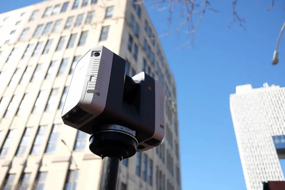 The Leica RTC360 pictured 3D laser scanning the exterior of an urban building.