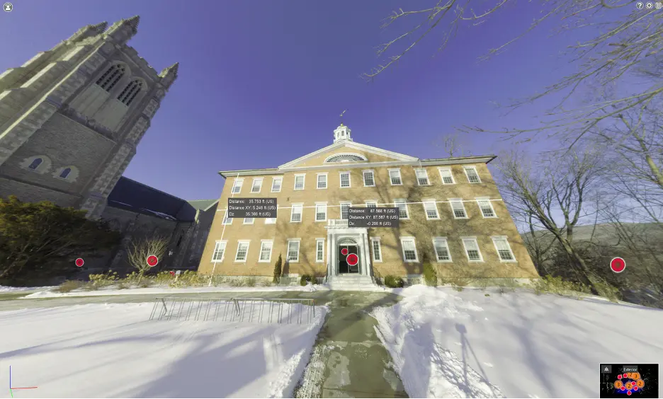 TruView of a large, multi-story brick building with white trim and many windows, surrounded by snow.