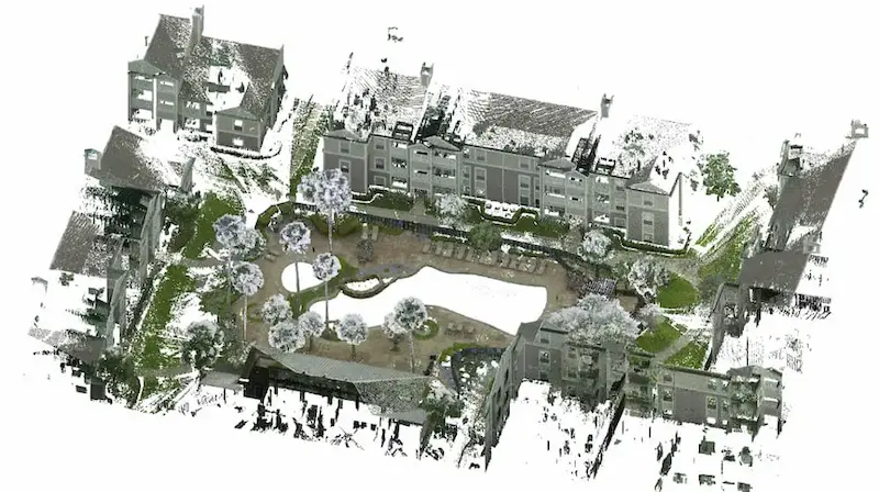 A color point cloud image of a residential complex featuring multiple buildings arranged around a central courtyard.