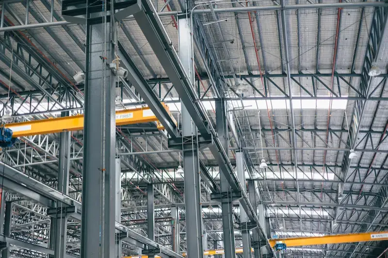 A large warehouse with metal beams.